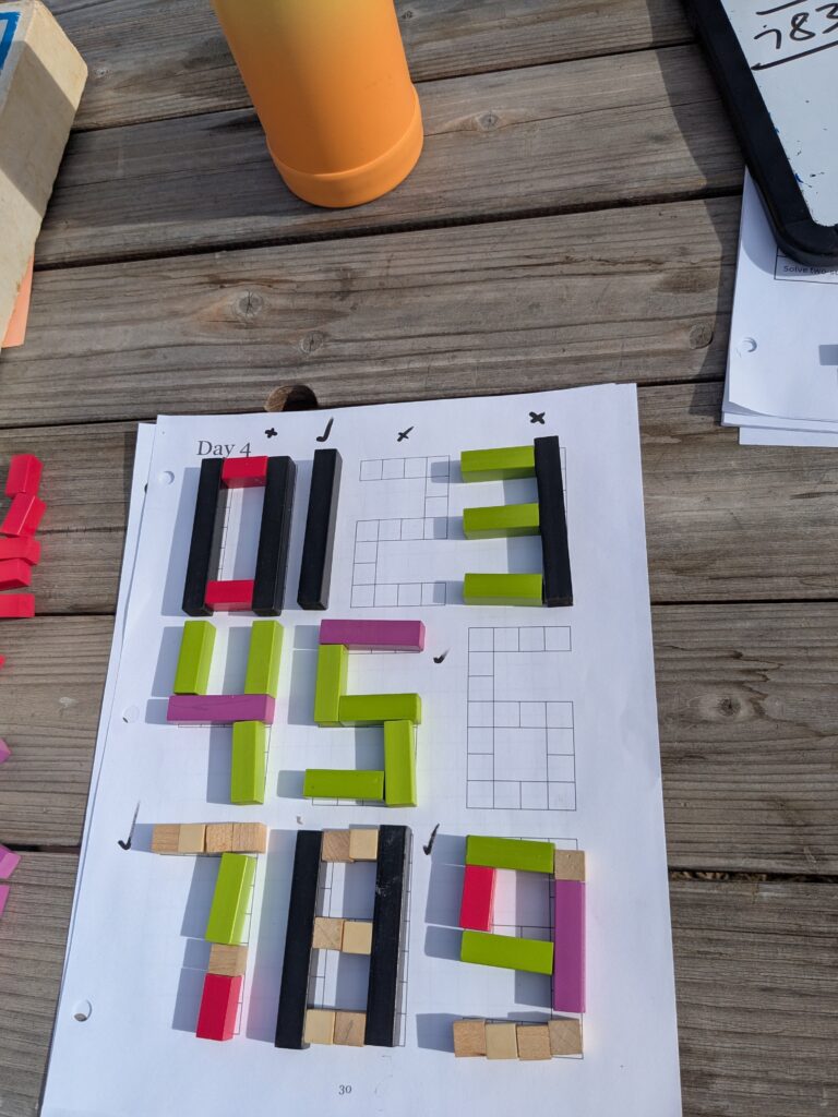 Numbers on graph paper filled in with Cuisenaire rods.